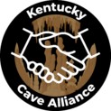 Logo of Kentucky Cave Alliance showing a handshake symbolizing collaboration, with cave formations in the background and the text 'Kentucky Cave Alliance' on a black circular ring.